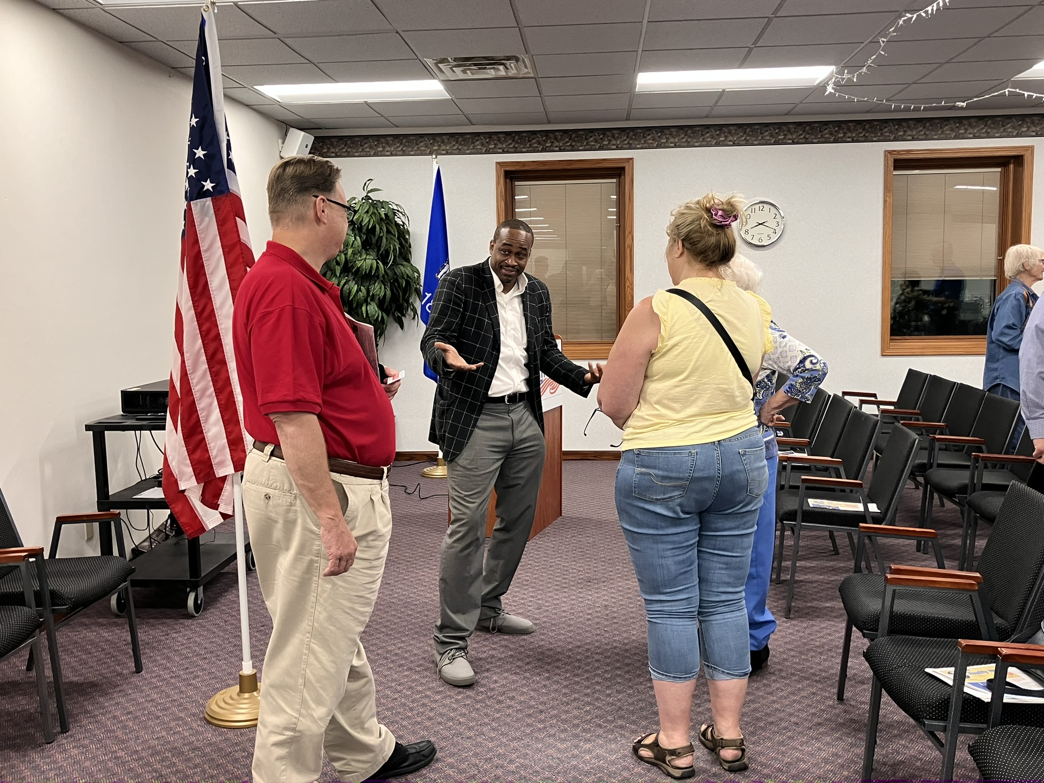 Larry Thomas Jr. visits with members of Fox Valley Initiative after its September meeting.