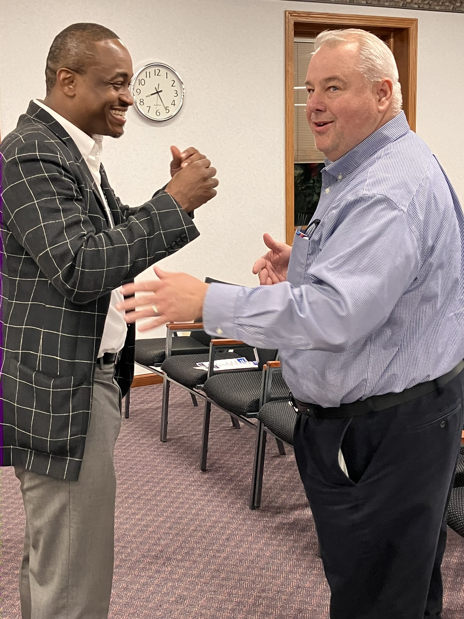 Larry Thomas Jr. visits with members of Fox Valley Initiative after its September meeting.