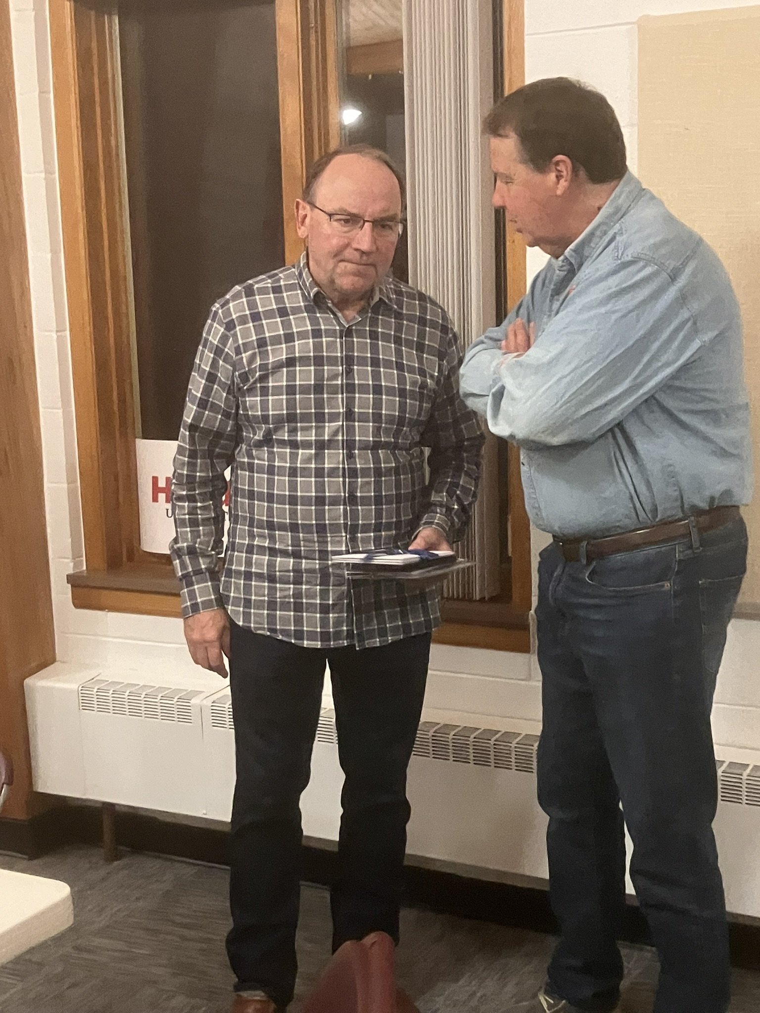 Congressman Tom Tiffany chats with Steve Welcenbach, publisher of Reality News, after the October 17 NEW Patriots meeting.